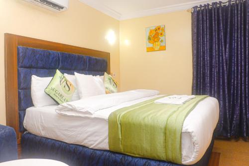 Cama o camas de una habitación en Sugarland Hotel and Suite GRA Ikeja Lagos