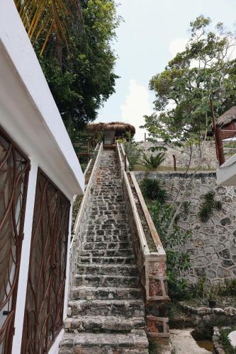 a set of stone stairs next to a building at Tucán Villages Bacalar Lagoon Front in Bacalar