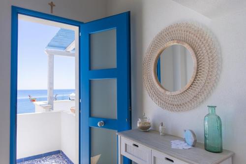 a bathroom with a blue door and a mirror at Marettimo Vacanze in Marettimo