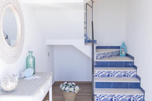 a staircase in a room with blue and white tiles at Marettimo Vacanze in Marettimo