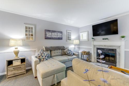 a living room with a couch and a fireplace at Norwich Vacation Rental with Golf Course Views! in Norwich