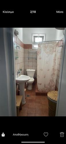 a bathroom with a sink and a toilet and a shower at Kanala house in Kithnos