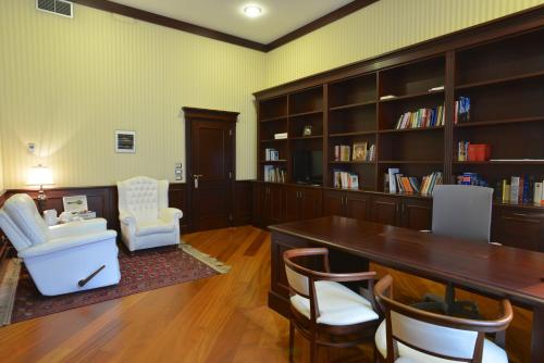 a library with a table and chairs and book shelves at Domus Australia in Rome