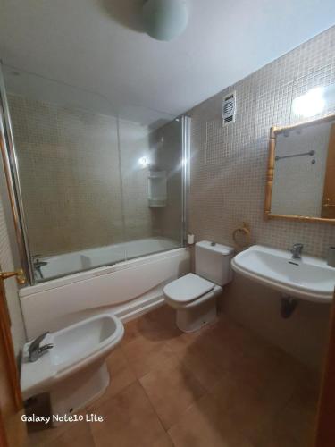 a bathroom with a tub and a toilet and a sink at Manilva chill in Manilva