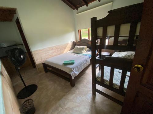 a bedroom with two bunk beds and a fan at Hospedaje la Macarena in Berlín