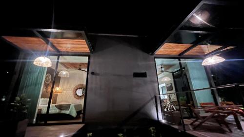 a view of a house at night with lights at Namu Garden Hotel & Spa - Adults Only in Puerto Viejo