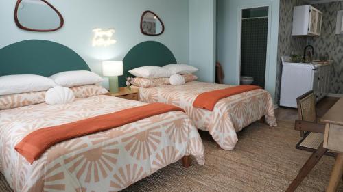 A bed or beds in a room at The Savannah Inn