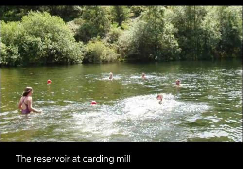 a group of people swimming in a river at The Views in Church Stretton