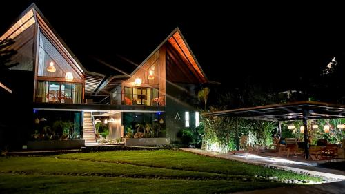 a house at night with a lawn in front of it at Namu Garden Hotel & Spa - Adults Only in Puerto Viejo
