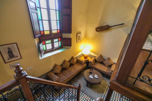 a living room with a couch and a table at Ryad Mabrouka in Fès