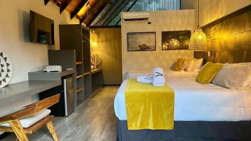 a bedroom with a bed with towels on it at Namu Garden Hotel & Spa - Adults Only in Puerto Viejo