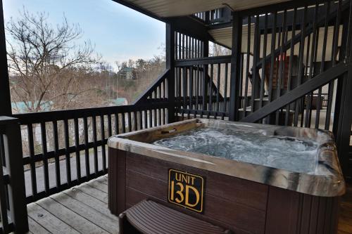 a jacuzzi tub on a deck on a porch at Briarstone Lodge Condo 13D by Eden Crest in Pigeon Forge