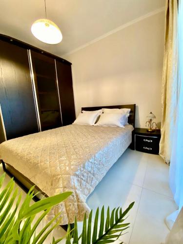 a bedroom with a bed and a plant at Villas Hanioti in Hanioti