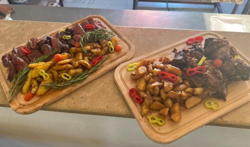 two cutting boards filled with different types of food on a counter at Imperial Hotel in Ulcinj