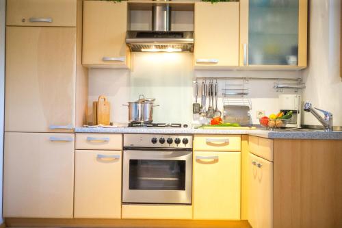 a kitchen with yellow cabinets and a stove top oven at Schlossblick in Vols am Schlern