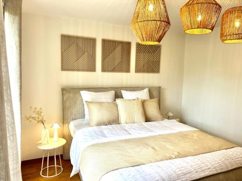 a bedroom with a bed and two chandeliers at Friends & Family Brussels Atomium 6-8 pers in Grimbergen