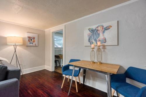 a living room with a table and blue chairs at #StayinMyDistrict Heritage House Pet Friendly Apartment in Coos Bay