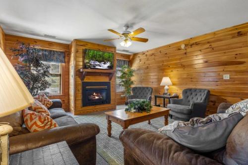 a living room with leather furniture and a fireplace at Poplar Point Condo Unit 12F by Eden Crest in Pigeon Forge