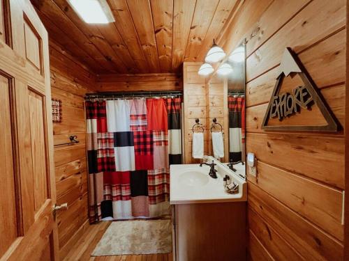 a bathroom with a sink in a wooden cabin at Spacious, dog friendly cabin in Blowing Rock, NC in Blowing Rock