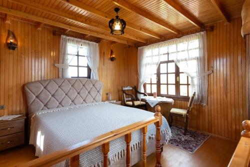 a bedroom with a bed in a room with wooden walls at Yücebaş Konağı in Fatsa
