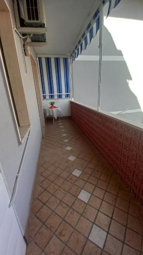 a hallway with a room with a table and a window at Clera in Scalea