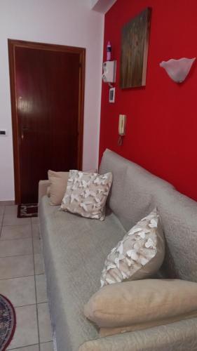 a couch in a living room with pillows on it at Clera in Scalea