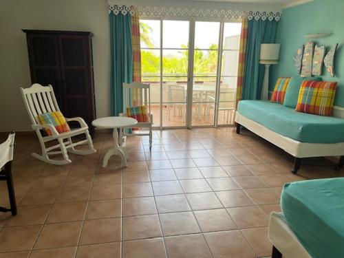 a living room with a bed and a table at TROPIC Appartements PREMIUM village pierre et vacances vue mer Martinique in Sainte-Luce