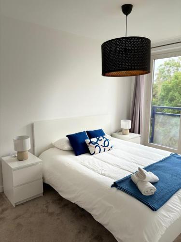 - une chambre avec un grand lit blanc et des serviettes dans l'établissement Charming Apartement Luxembourg City Center, Parking, Balcony, à Luxembourg