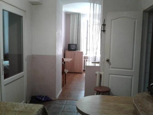 a living room with a table and a room with a door at М.Арнаутская 33 in Odesa