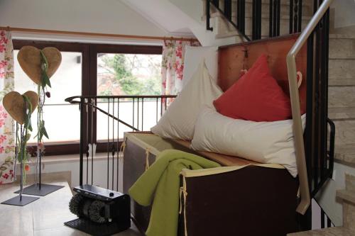 a bed with red and white pillows in a room at Landgasthof Fischer Veri in Mitterfels