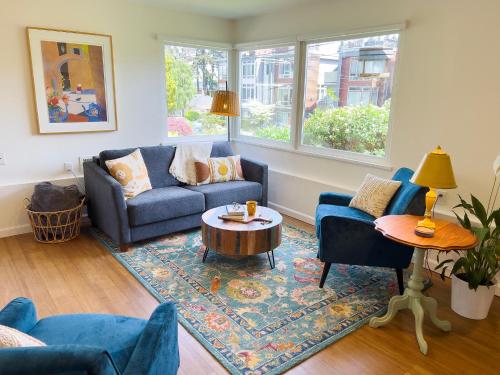 a living room with a couch and a table at Magnolia Garden Cottage in Seattle