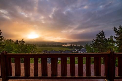 a wooden bench with the sunset in the background at Panorama Kobylnice in Lipno nad Vltavou