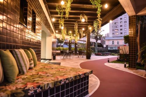 a patio with a bench in the middle of a building at Plaza Inn Small Town Flat in Sao Paulo