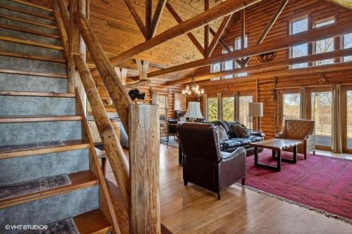 a living room with a staircase in a house at Scout's Haven in Rolling Prairie