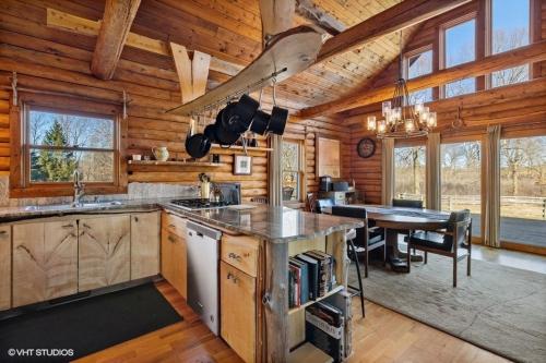 a kitchen and dining room with a table in a cabin at Scout's Haven in Rolling Prairie