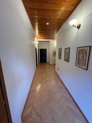 a hallway with white walls and a wooden ceiling at Vila AT in Berat