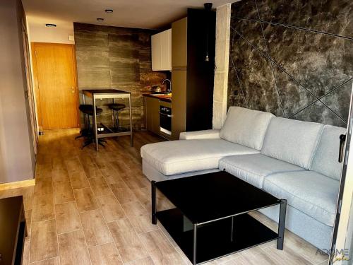 a living room with a couch and a table at ADOME Apartment Primavera in Santa Pola