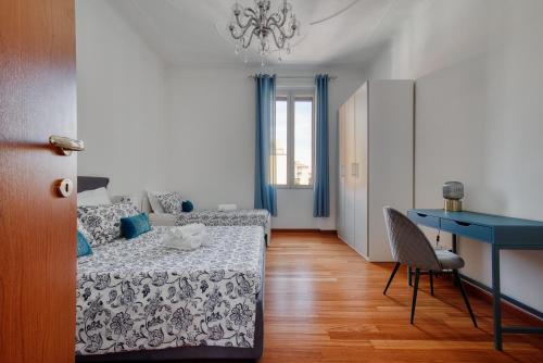 a bedroom with a bed and a table and a desk at Lattanzio Charming Suite - Porta Romana MM3 in Milan