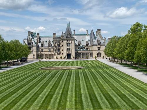 a large castle with a green lawn in front of it at Mills Gap Garden close to Asheville in Fletcher
