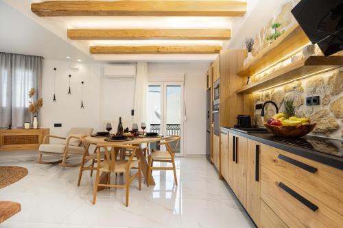 a kitchen and dining room with a table and chairs at Lago m Superior Naxos Town in Naxos Chora