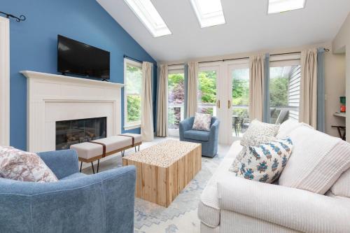 a living room with blue walls and a fireplace at Mills Gap Garden close to Asheville in Fletcher