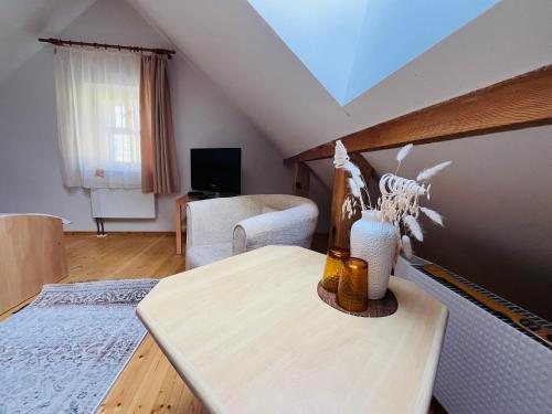 een woonkamer met een tafel en een bank bij In heart of Trakai you'll find authentic Karaim house in Trakai
