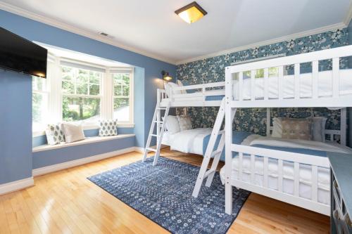 a bedroom with two bunk beds and blue walls at Mills Gap Garden close to Asheville in Fletcher
