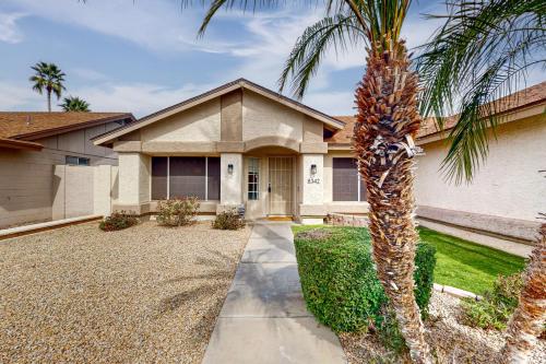 a palm tree in front of a house at Peoria Palms in Peoria