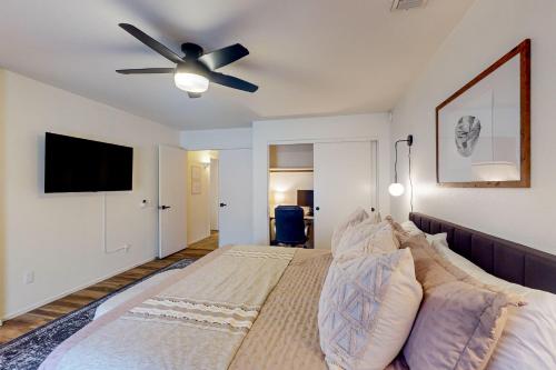 a bedroom with a bed with a ceiling fan at Peoria Palms in Peoria