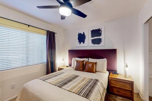 a bedroom with a bed and a ceiling fan at Peoria Palms in Peoria