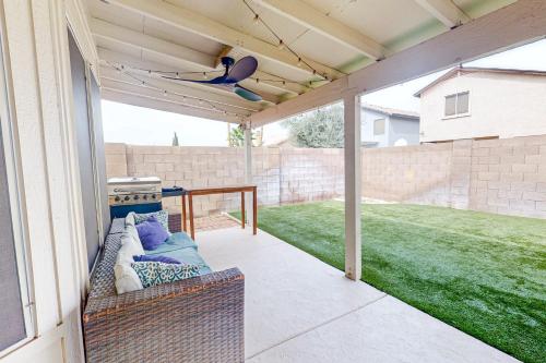 a screened in porch with a ceiling fan at Peoria Palms in Peoria