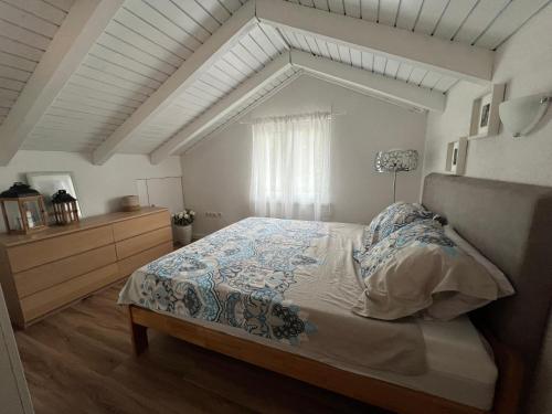 a bedroom with a bed and a dresser at Wolf country haus in Sesvete