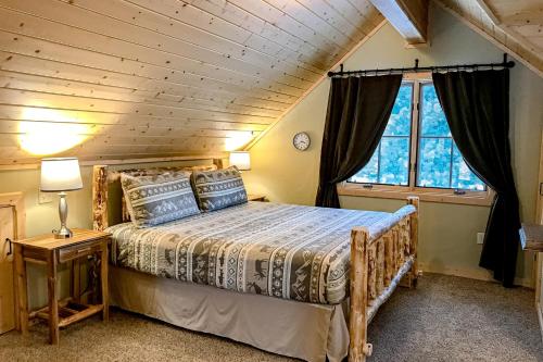 a bedroom with a bed with a wooden ceiling at Poppy's Place Studio in South Fork