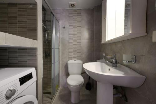 a bathroom with a toilet and a sink at Corfu Glyfada Beach Apartment in Glyfada